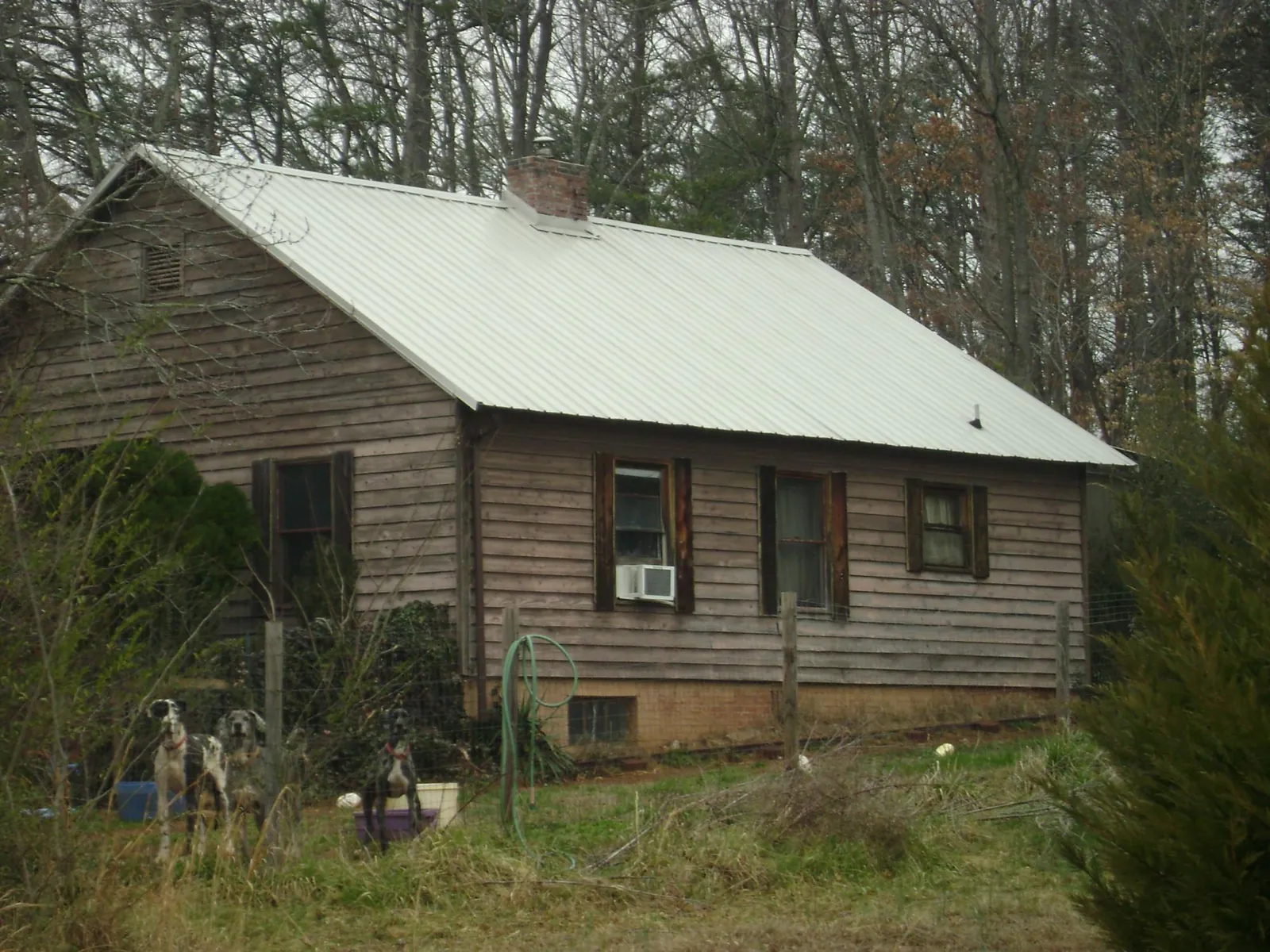 White metal roof on an old wood sided farmhouse, from a Metal Roof Installation job in Colonia